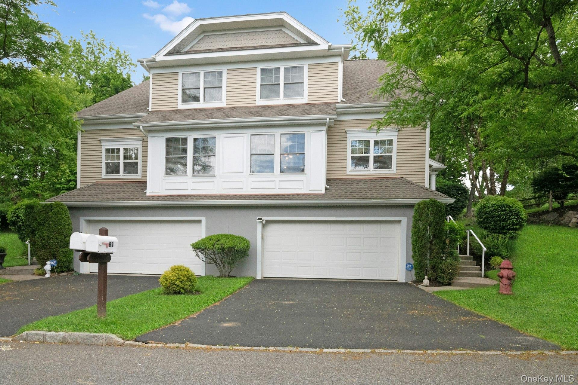 Semi attached townhouse with 2 car garage and driveway.
