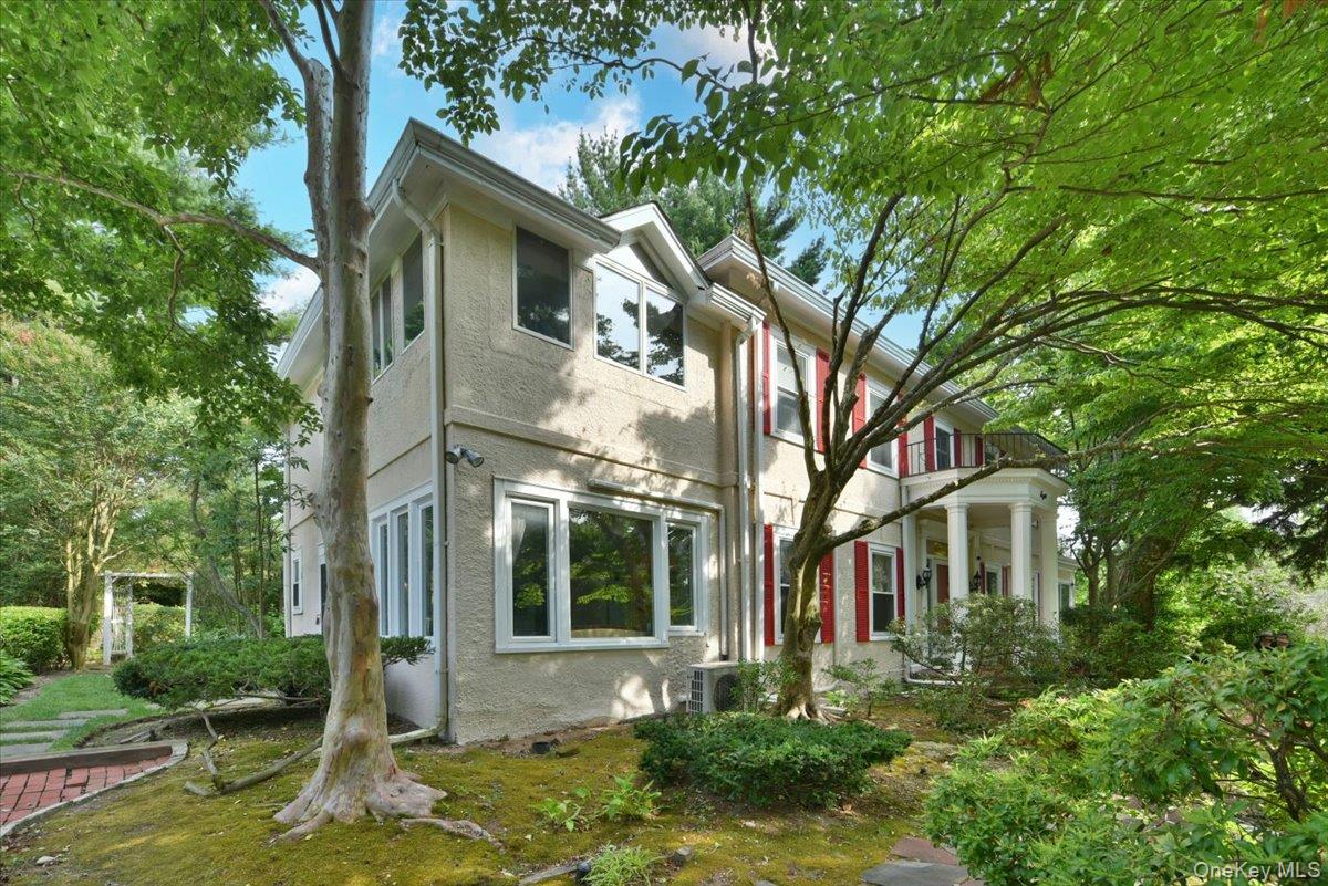 Back of property featuring a balcony and stucco siding