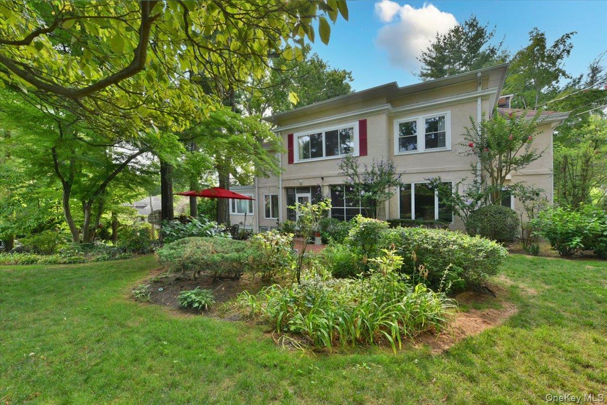 Rear view of house with a yard and stucco siding