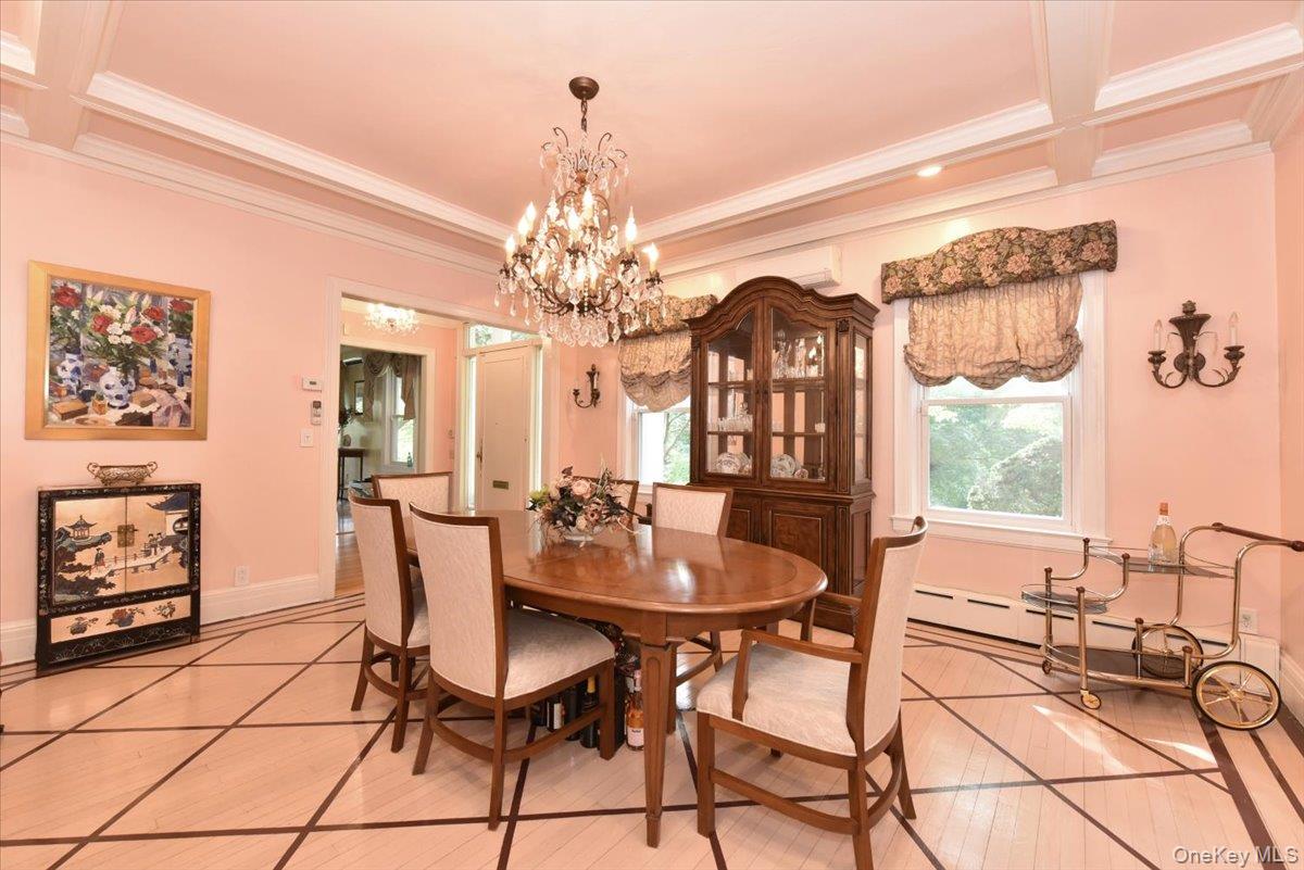Dining space with a notable chandelier, baseboards, and crown molding