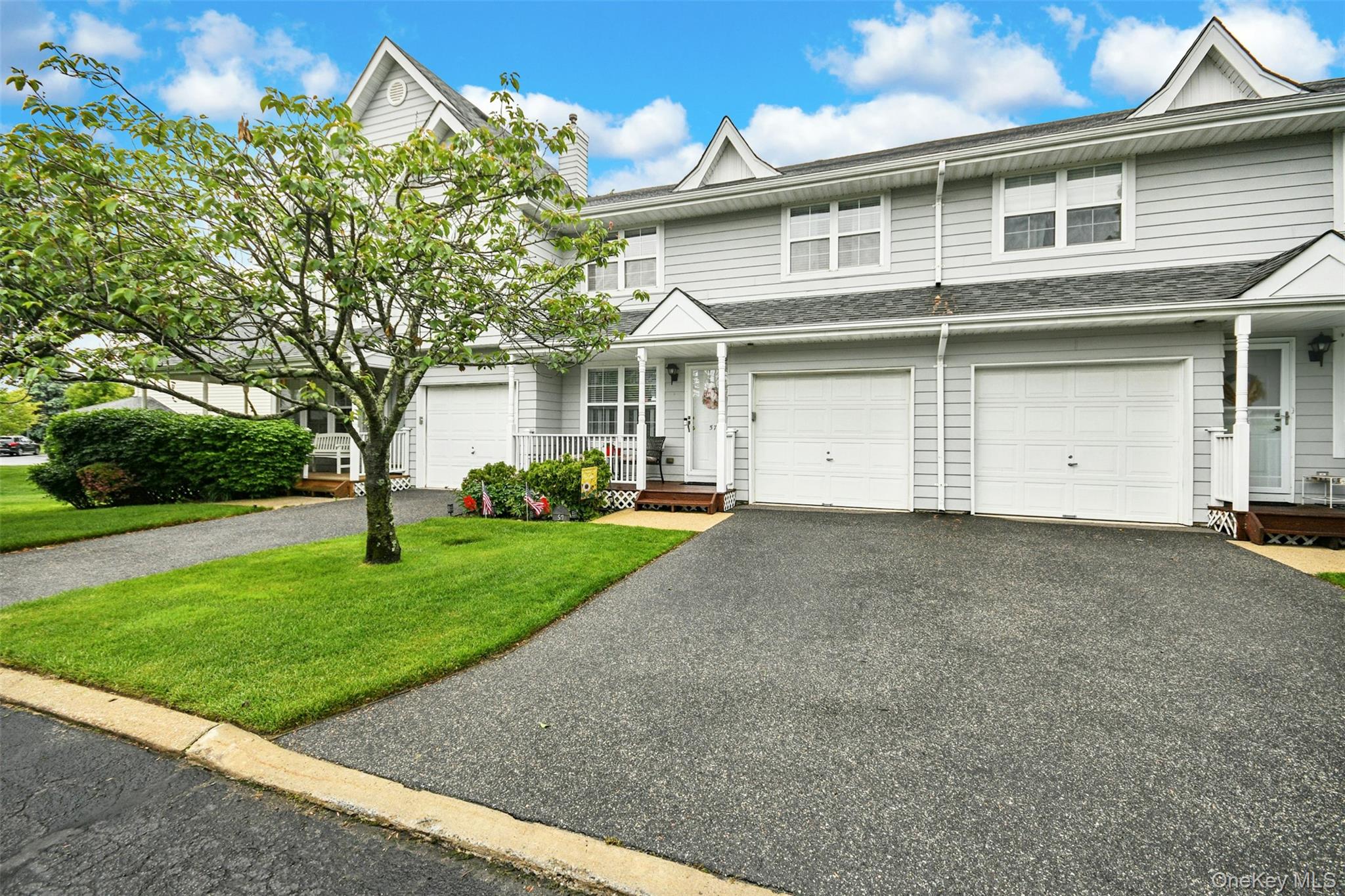 Townhome exterior featuring light gray siding with white trim