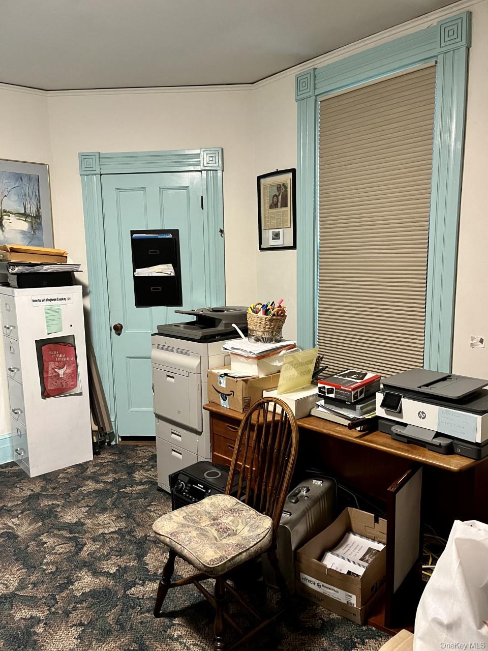 Office area featuring dark colored carpet