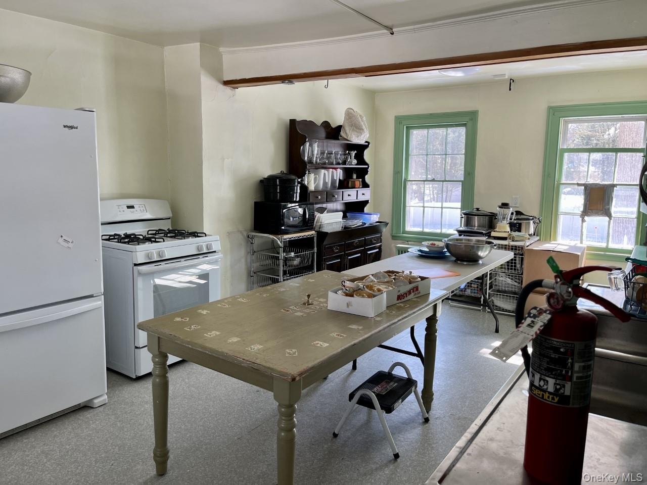 Kitchen with white appliances and healthy amount of natural light