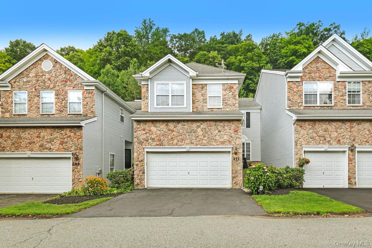 Multi-story townhome with a stone and siding exterior
