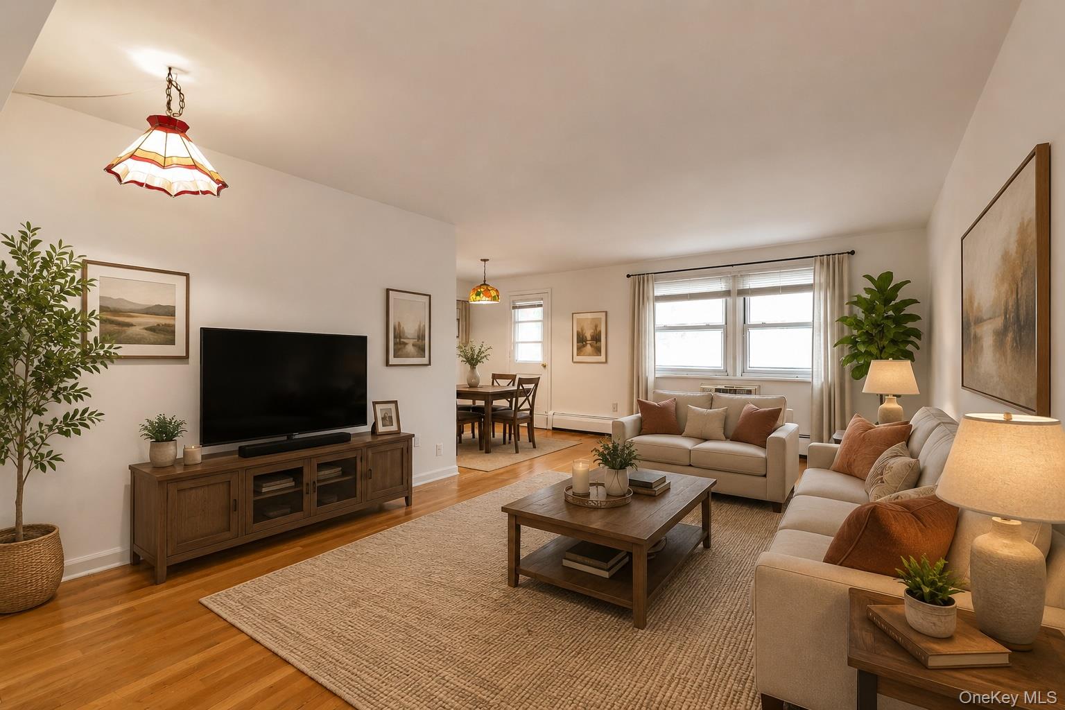 Virtually Staged Living Room / Dining Area with Hardwood Floors