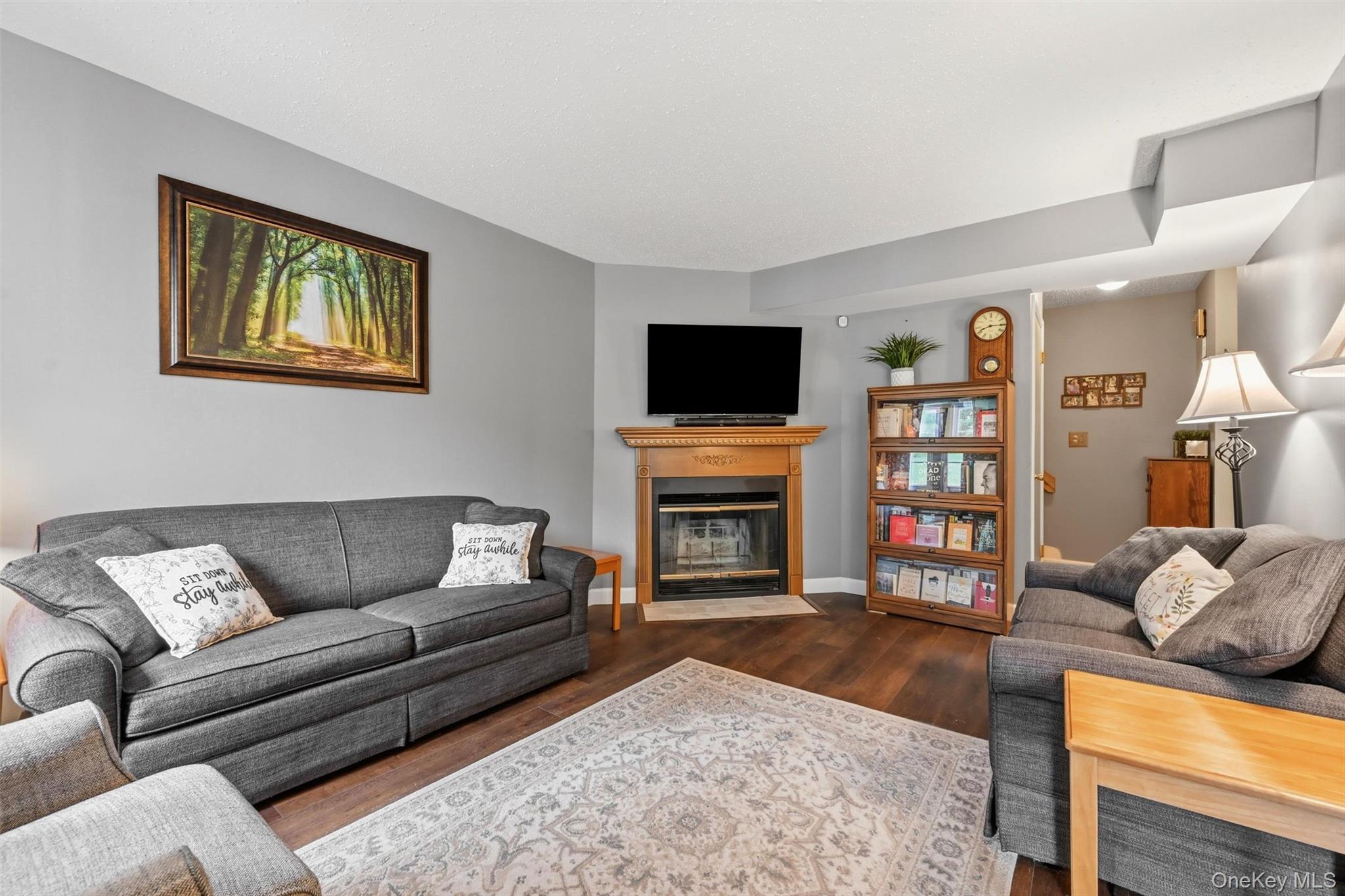 Living room with beautiful floors and wood burning fireplace