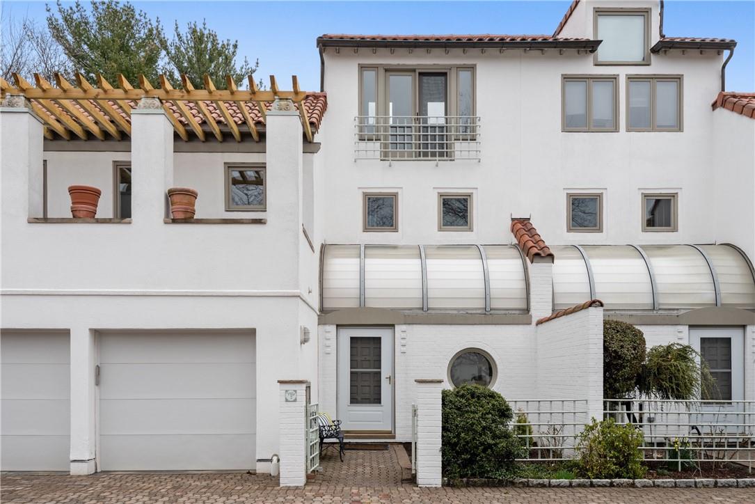 Front entrance with small garden. Two car garage
